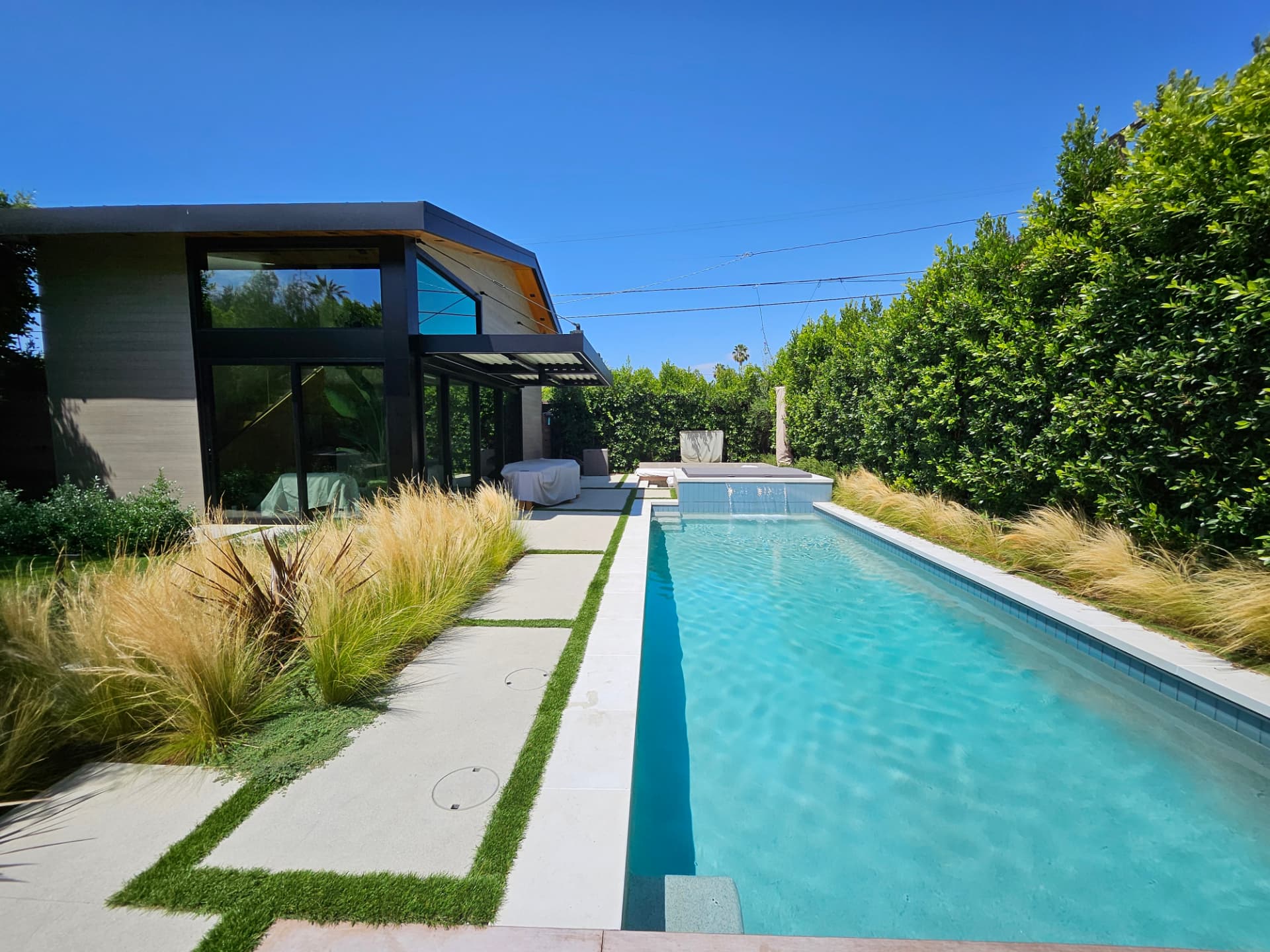 Contemporary lap pool alongside a modern Eagle Rock home